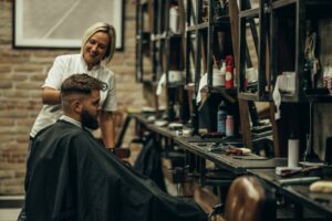 young-bearded-man-getting-haircut-by-hairdresser-2023-11-27-05-00-08-utc